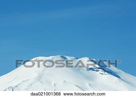 Stock Photo - Snow-covered mountain peak. Fotosearch