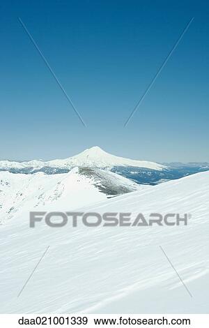 Stock Photo - Snow-covered mountainous landscape. Fotosearch
