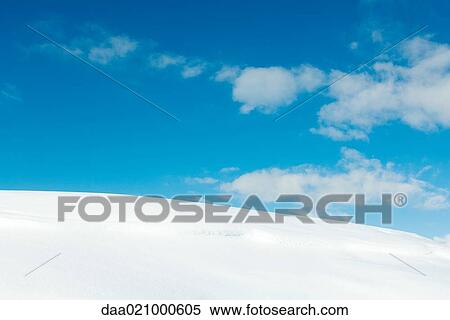 Snow-covered slope and blue sky View Large Photo Image Stock Photography - Snow-covered slope and blue sky. Fotosearch