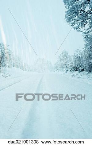 Snow falling over snow-covered road View Large Photo Image Stock Photo - Snow falling over snow-covered road. Fotosearch