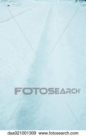 Snow falling over snow-covered road, close-up View Large Photo Image Stock Photo - Snow falling over snow-covered road, close-up. Fotosearch