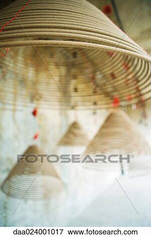 Spirals of incense hanging from ceiling, focus on foreground View Large Photo Image Stock Photo - Spirals of incense hanging from ceiling, focus on foreground. Fotosearch