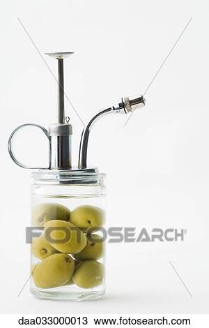 Stock Image - Spray bottle with olives inside. Fotosearch