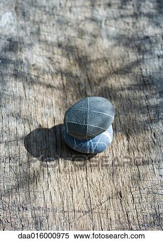 Stacked pebbles on wood View Large Photo Image Stock Photography - Stacked pebbles on wood. Fotosearch