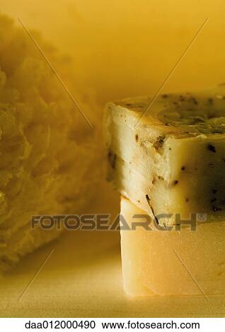 Stock Image - Stacked soaps and natural sponge. Fotosearch