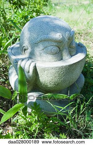 Stone statue in Japanese ornamental garden View Large Photo Image Stock Photo - Stone statue in Japanese ornamental garden. Fotosearch