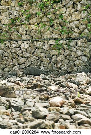 Picture - Stone wall and stone covered ground. Fotosearch