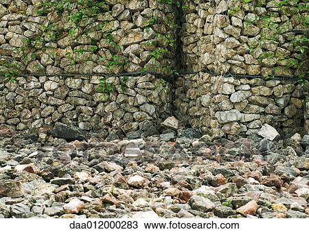 Stone wall and stone covered ground View Large Photo Image Stock Image - Stone wall and stone covered ground. Fotosearch