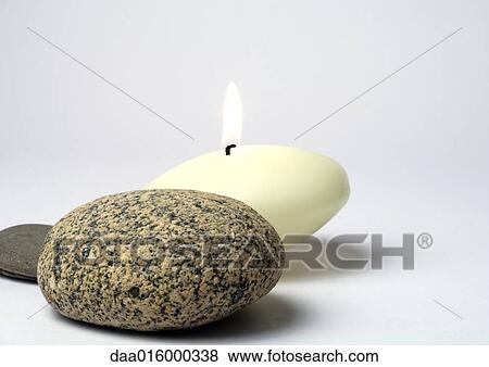 Stones and candle View Large Photo Image Stock Photo - Stones and candle. Fotosearch