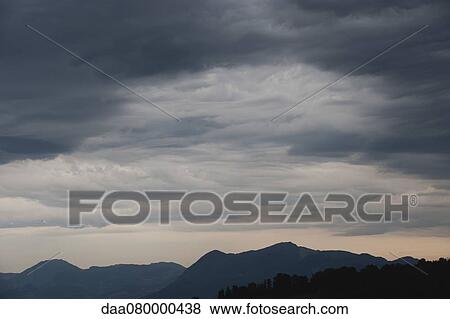 Storm clouds over mountain landscape View Large Photo Image Stock Photo - Storm clouds over mountain landscape. Fotosearch