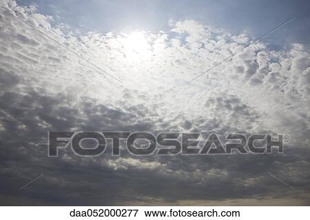 Sun peaking out from behind clouds View Large Photo Image Stock Photo - Sun peaking out from behind clouds. Fotosearch