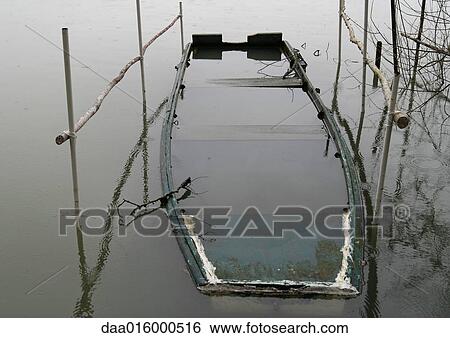 Stock Photograph - Sunken rowboat in shallow water. Fotosearch
