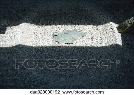 Stock Image - Sunlight and shadow on rock garden, close-up. Fotosearch
