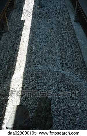 Stock Photography - Sunlight and shadow on rock garden. Fotosearch