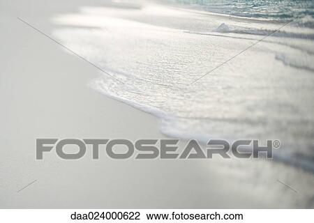 Surf washing up on sand, close-up View Large Photo Image Stock Image - Surf washing up on sand, close-up. Fotosearch
