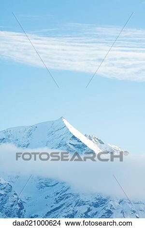 Switzerland, clouds moving over snowy mountains View Large Photo Image Picture - Switzerland, clouds moving over snowy mountains. Fotosearch