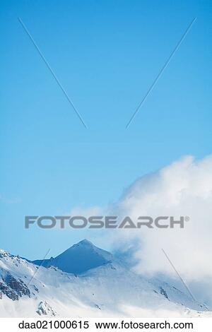 Switzerland, clouds moving over snowy mountains View Large Photo Image Stock Photography - Switzerland, clouds moving over snowy mountains. Fotosearch