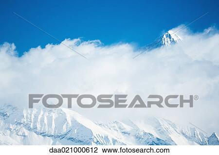 Switzerland, mountains surrounded by clouds View Large Photo Image Stock Image - Switzerland, mountains surrounded by clouds. Fotosearch