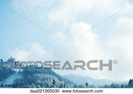 Stock Image - Switzerland, Vaud canton, Lavaux region, snowy mountain landscape with castle. Fotosearch