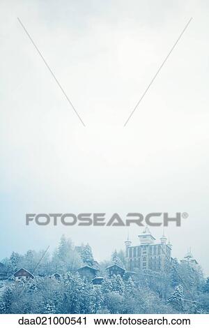 Stock Image - Switzerland, Vaud canton, Lavaux region, snowy mountain landscape with castle. Fotosearch