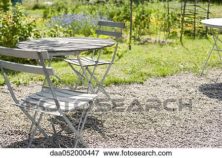 Table and chair on backyard terrace View Large Photo Image Stock Photo - Table and chair on backyard terrace. Fotosearch