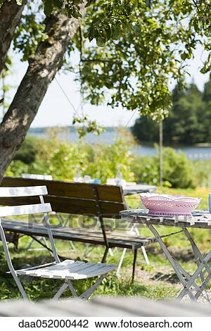 Stock Image - Table and chairs in backyard. Fotosearch