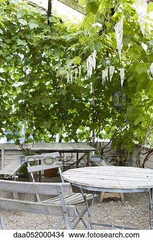 Picture - Tale and chairs on outdoor patio. Fotosearch