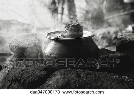 Stock Image - Tea being prepared, China. Fotosearch