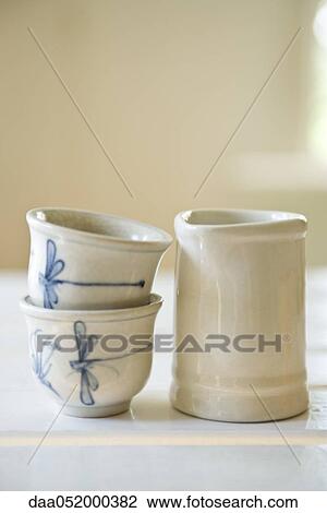 Teacups stacked next to cream jug View Large Photo Image Stock Image - Teacups stacked next to cream jug. Fotosearch