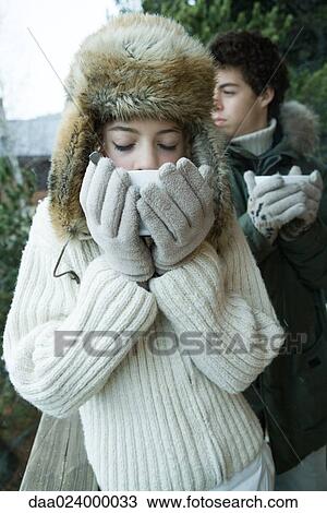 Teen boy and girl in winter clothes drinking warm drinks View Large Photo Image Stock Image - Teen boy and girl in winter clothes drinking warm drinks. Fotosearch