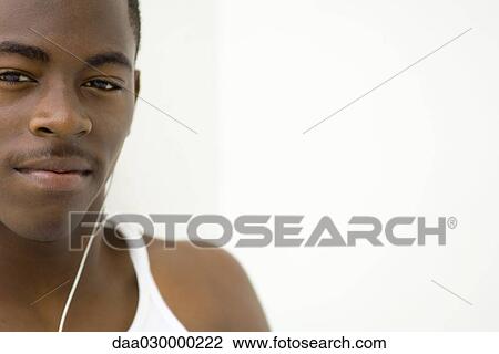 Teen boy listening to earphones, portrait, cropped View Large Photo Image Stock Image - Teen boy listening to earphones, portrait, cropped. Fotosearch