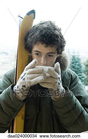 Teen boy with skis drinking warm drink View Large Photo Image Picture - Teen boy with skis drinking warm drink. Fotosearch