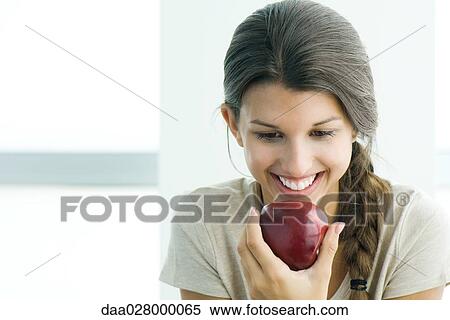 Teen girl eating apple, head and shoulders View Large Photo Image Stock Photography - Teen girl eating apple, head and shoulders. Fotosearch