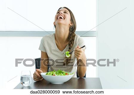 Teen girl eating salad, laughing with head back View Large Photo Image Stock Photo - Teen girl eating salad, laughing with head back. Fotosearch