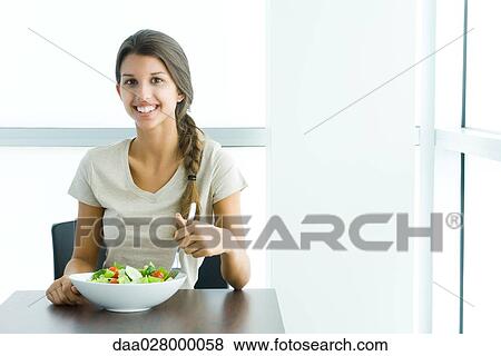 Teen girl eating salad, smiling at camera View Large Photo Image Stock Photo - Teen girl eating salad, smiling at camera. Fotosearch