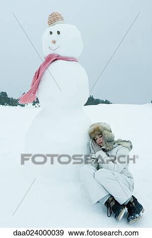 Teen girl leaning against snowman, sleeping View Large Photo Image Stock Photo - Teen girl leaning against snowman, sleeping. Fotosearch