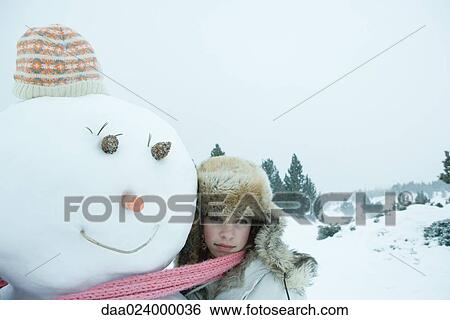 Teen girl sharing scarf with snowman View Large Photo Image Stock Photograph - Teen girl sharing scarf with snowman. Fotosearch