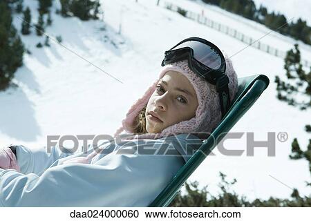 Teen girl sitting in chair in snowy landscape, looking at camera View Large Photo Image Stock Image - Teen girl sitting in chair in snowy landscape, looking at camera. Fotosearch