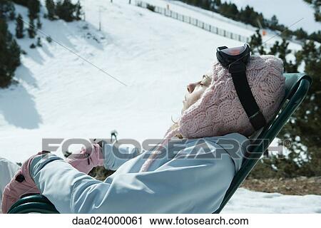 Teen girl sitting in chair in snowy landscape, relaxing in sun View Large Photo Image Stock Image - Teen girl sitting in chair in snowy landscape, relaxing in sun. Fotosearch