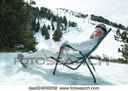 Teen girl sitting in chair in snowy landscape, relaxing in sun View Large Photo Image Stock Photo - Teen girl sitting in chair in snowy landscape, relaxing in sun. Fotosearch