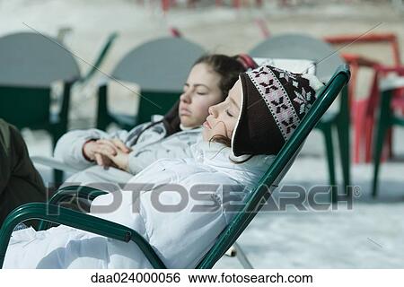 Teen girl sitting in chairs at ski resort, relaxing in sun View Large Photo Image Stock Photograph - Teen girl sitting in chairs at ski resort, relaxing in sun. Fotosearch