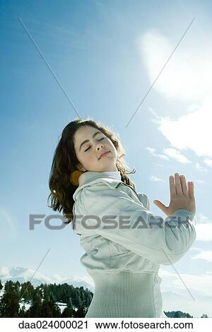 Teen girl standing in snowy landscape with eyes closed and hands clasped View Large Photo Image Stock Image - Teen girl standing in snowy landscape with eyes closed and hands clasped. Fotosearch