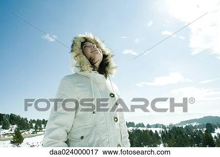 Teen girl standing in snowy landscape, low angle view View Large Photo Image Stock Photo - Teen girl standing in snowy landscape, low angle view. Fotosearch