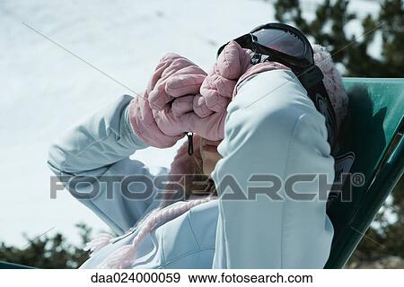 Teen girls sitting in chair in snowy landscape, rubbing eyes with backs of gloved hands View Large Photo Image Stock Photo - Teen girls sitting in chair in snowy landscape, rubbing eyes with backs of gloved hands. Fotosearch