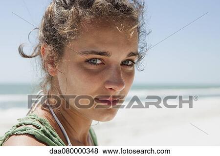 Stock Photo - Teenage girl at the beach, portrait. Fotosearch