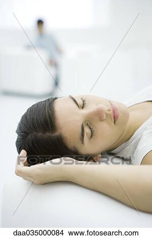 Teenage girl lying down, eyes closed View Large Photo Image Picture - Teenage girl lying down, eyes closed. Fotosearch
