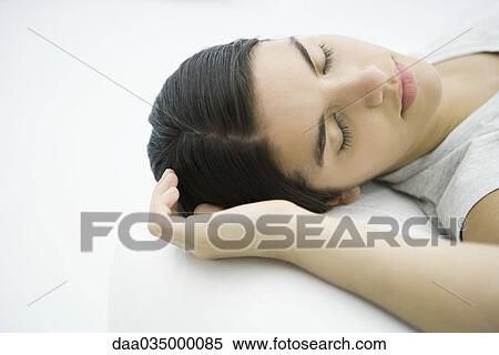 Teenage girl lying down, eyes closed View Large Photo Image Stock Photography - Teenage girl lying down, eyes closed. Fotosearch