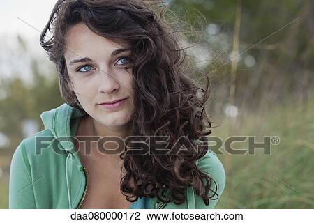 Stock Image - Teenage girl outdoors, portrait. Fotosearch