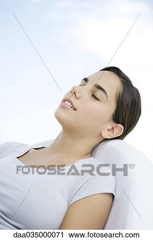 Teenage girl reclining in chair, eyes closed View Large Photo Image Stock Image - Teenage girl reclining in chair, eyes closed. Fotosearch