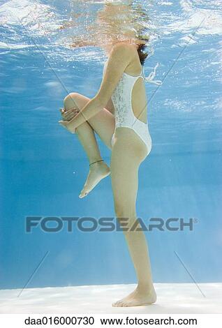 Teenage girl stretching leg underwater View Large Photo Image Stock Image - Teenage girl stretching leg underwater. Fotosearch
